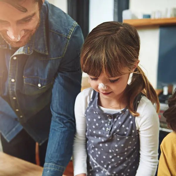 Parent helping child with homework showing family support